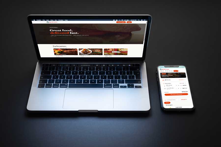 Laptop and phone showing the ePAY meals ordering site and menu order page